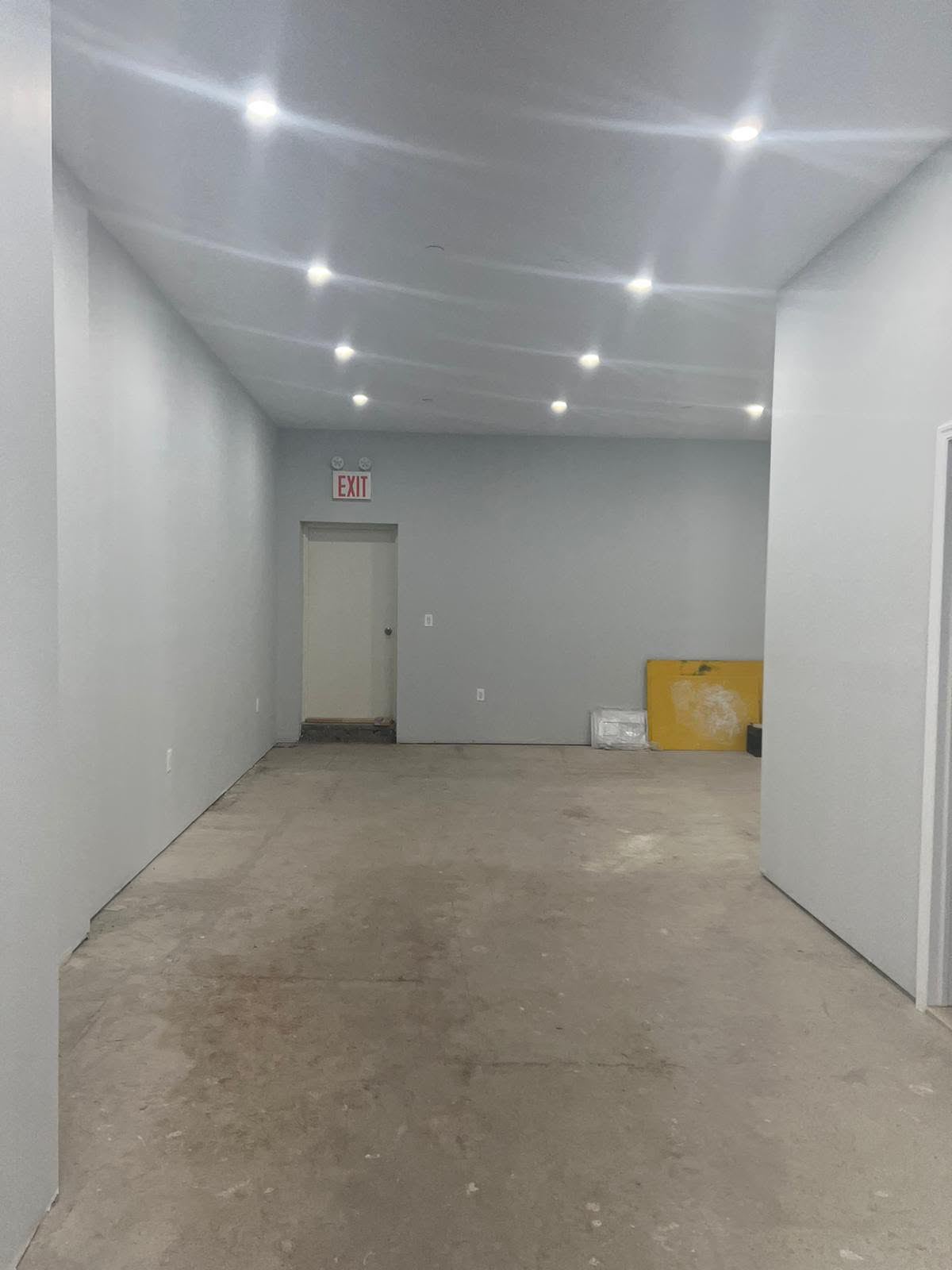 Empty raw commercial space before construction with bare concrete floor and unfinished walls