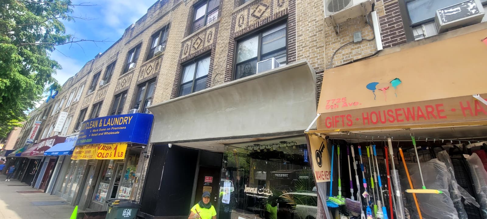 Restaurant storefront during renovation with a plain cement facade and dark covered entrance