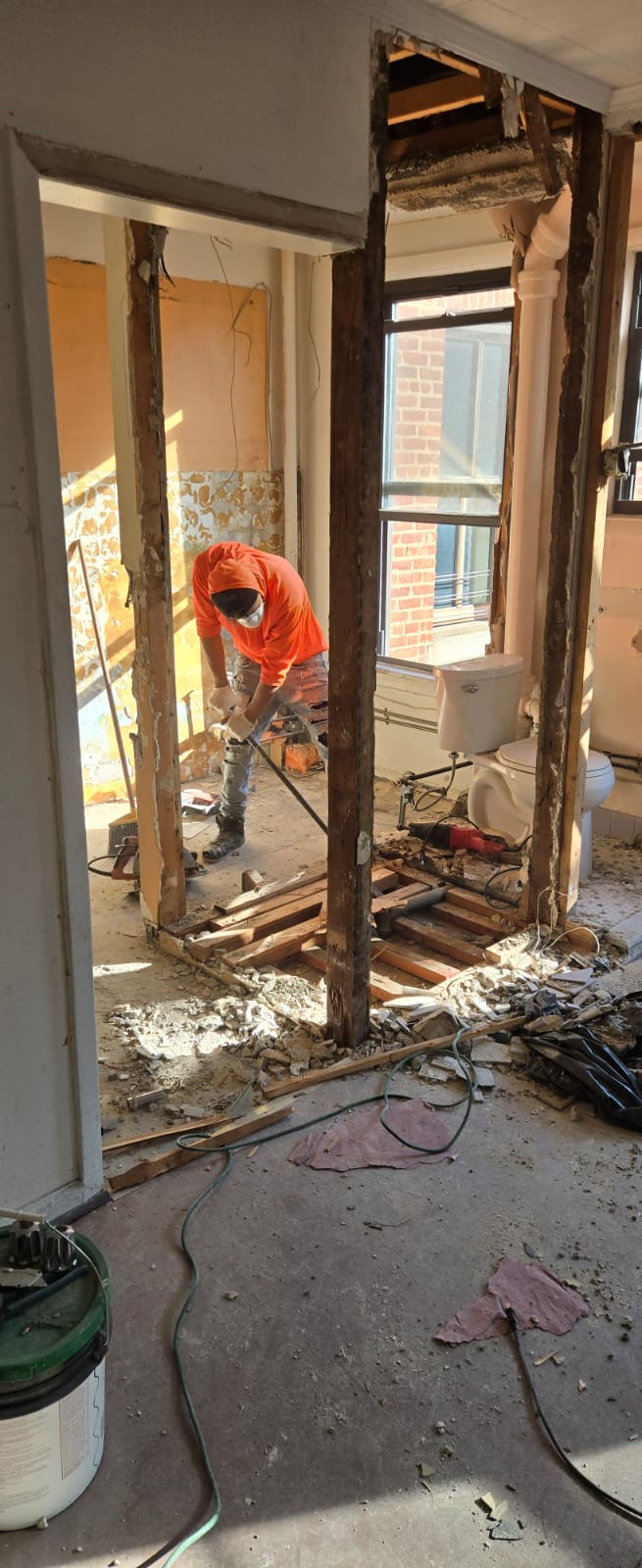 Interior demolition in progress with walls opened to the original timber framing